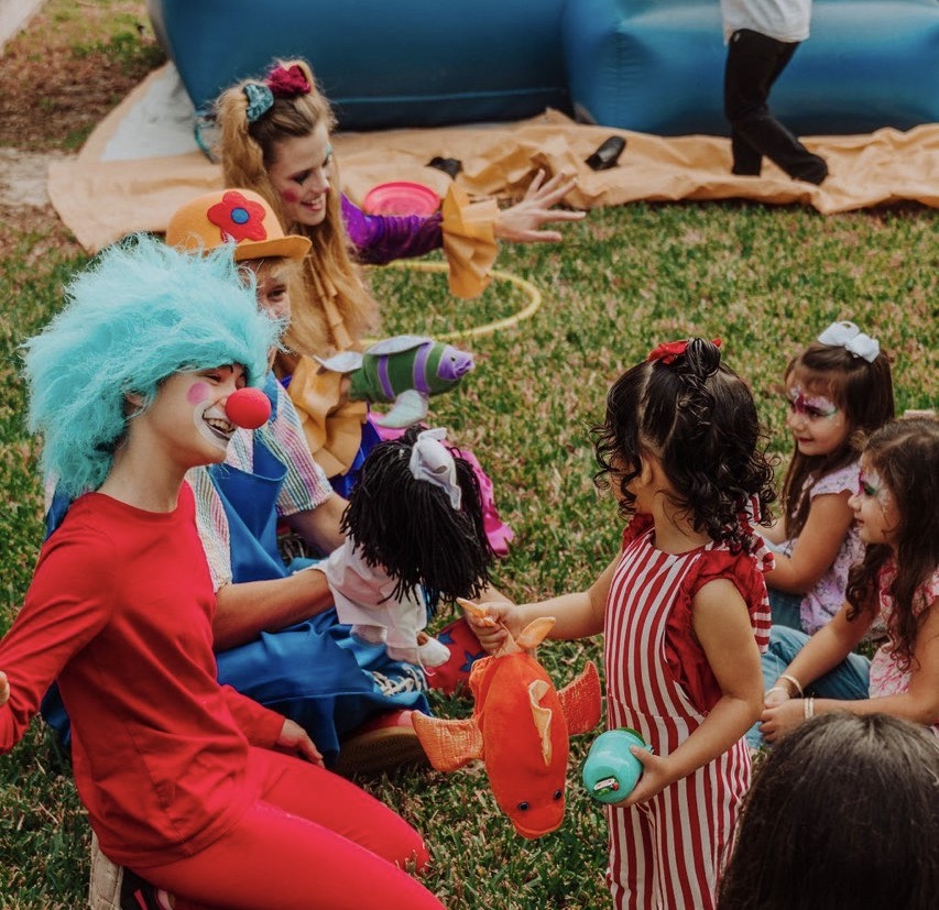 Blue hair party entertainer with children